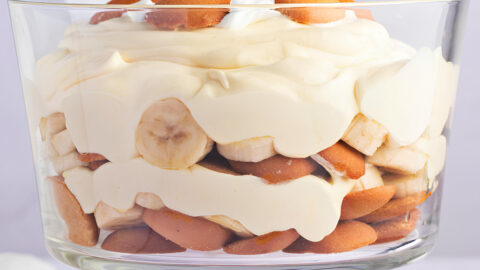 A Glass of Homemade Banana Pudding with Whipped Cream and Wafers