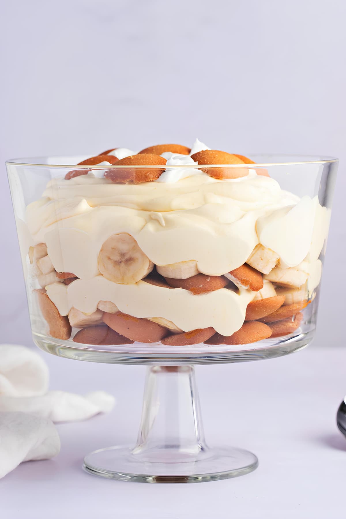 A Glass of Homemade Banana Pudding with Whipped Cream and Wafers
