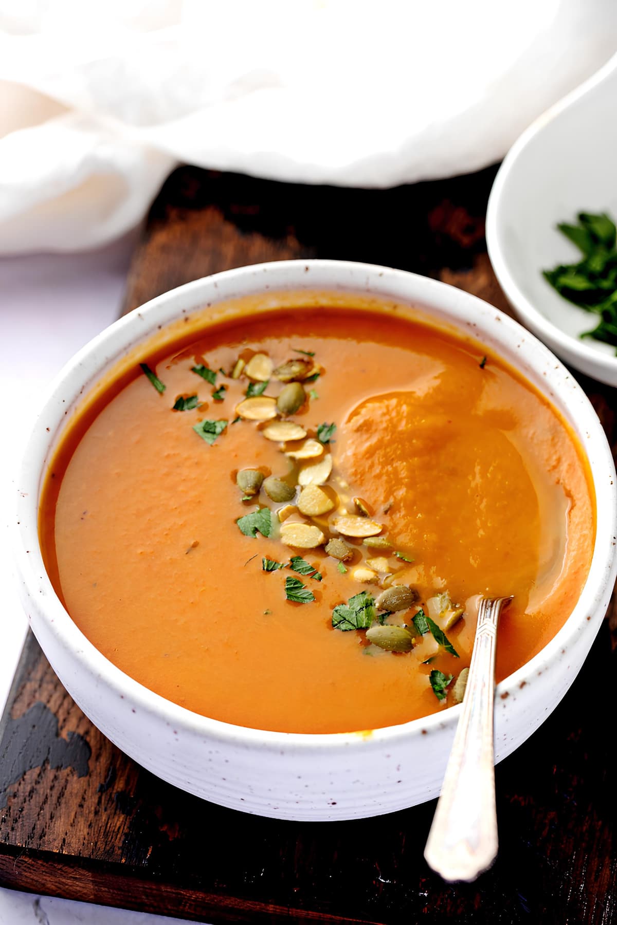 Warm and Creamy Pumpkin Soup in a White Bowl