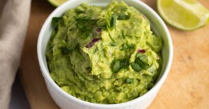 Appetizing Homemade Chipotle Guacamole in a Ramekin with Lime