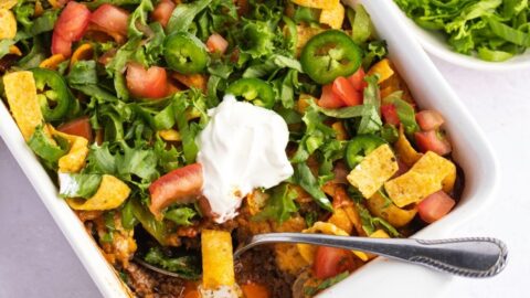 Homemade Taco Casserole with Tomatoes, Ground Beef, Frito Chips and Whipped Cream