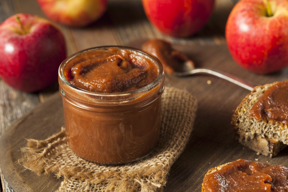 Apple Butter on a table with fresh apples