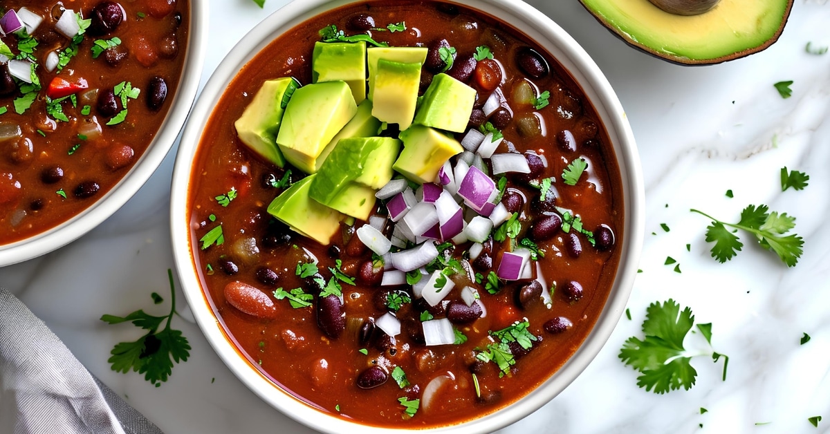 Healthy and delicious chipotle black bean soup with avocados and onions