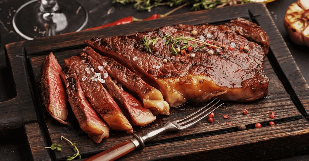 Juicy Ribeye Steak Sliced on a Cutting Board
