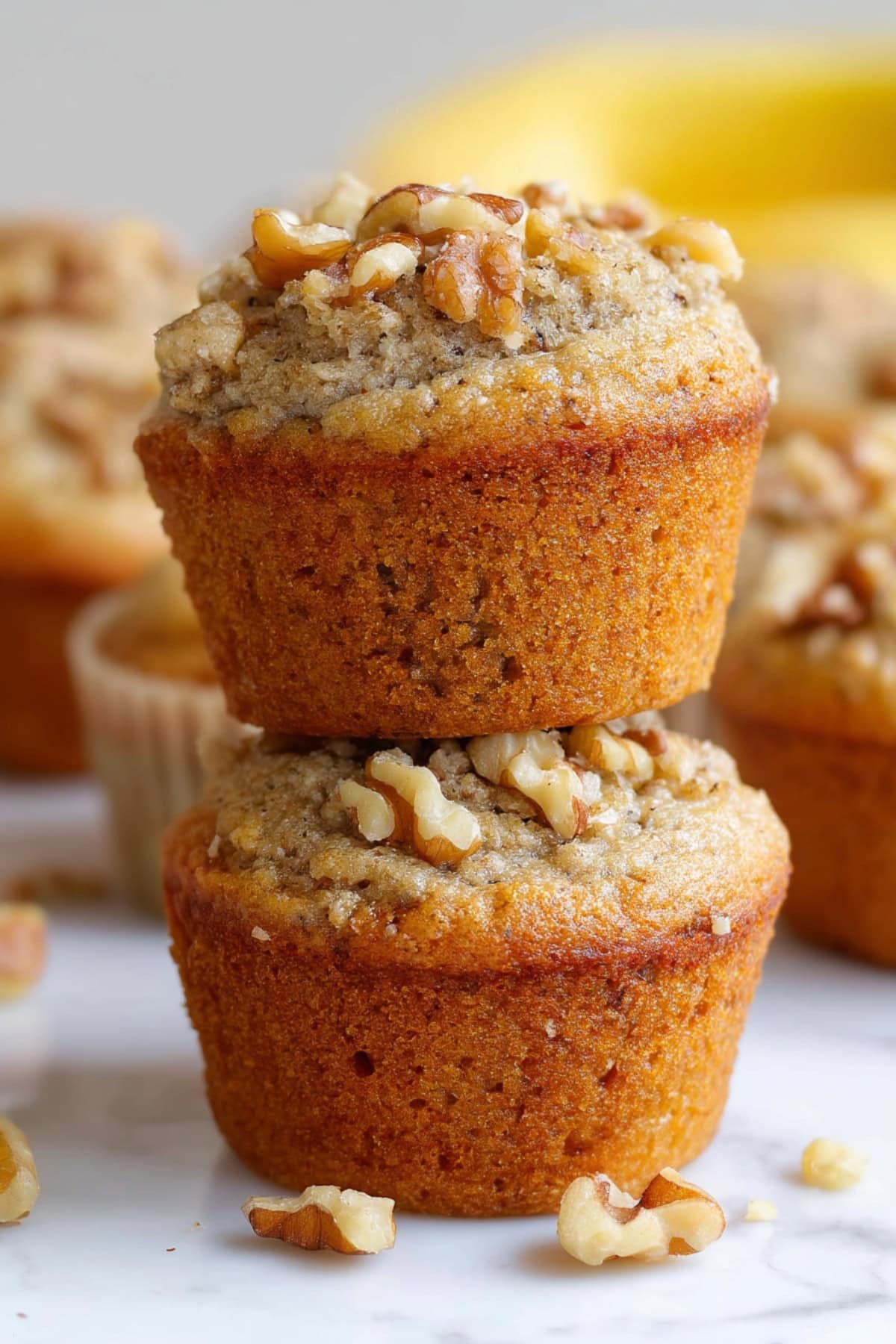A stack of Bisquick Banana Muffins with walnuts