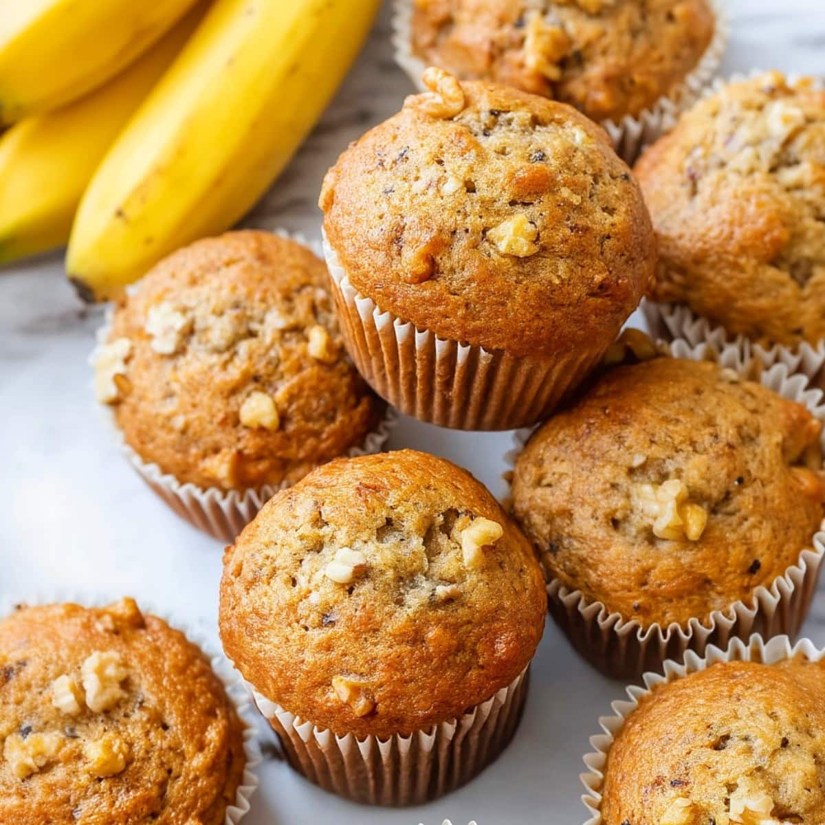 Bisquick Banana Muffins on a white marble table