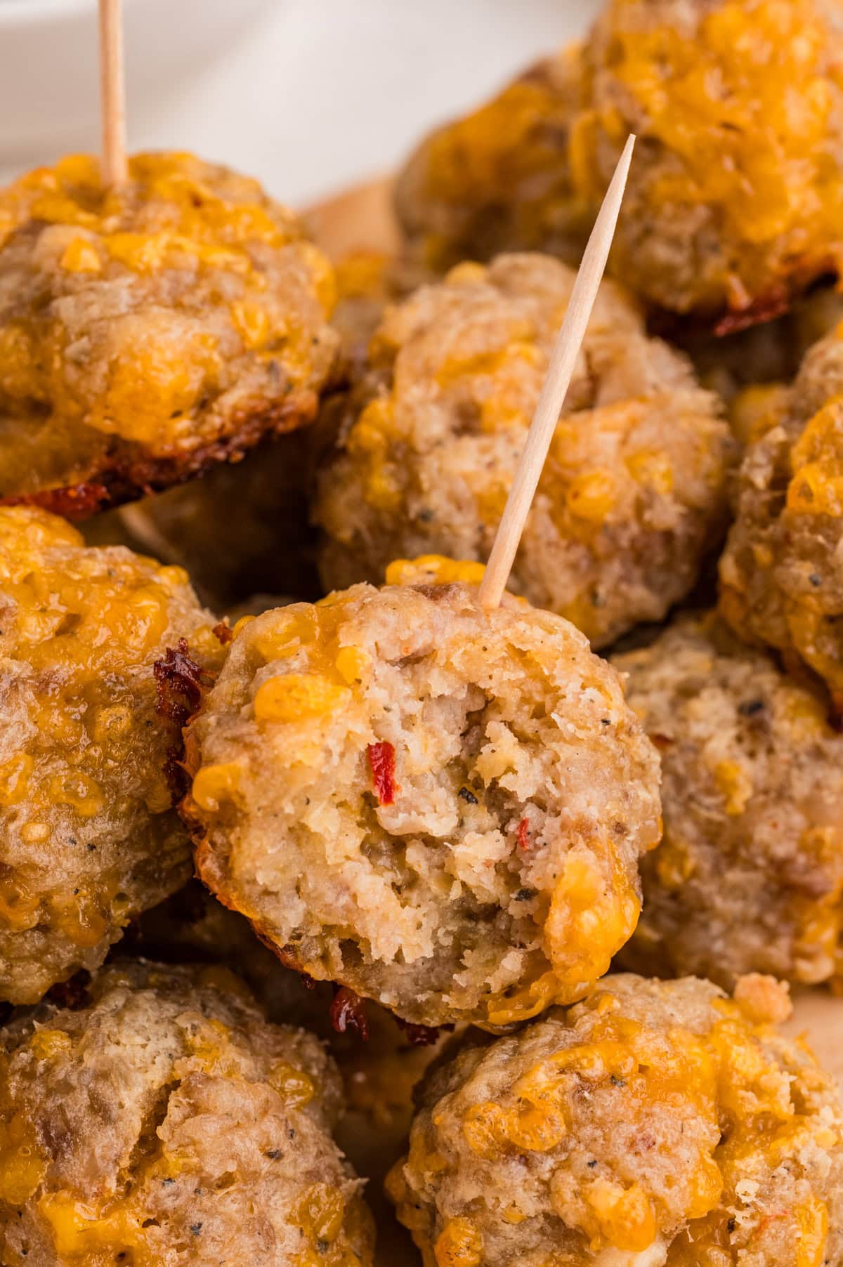 close-up photo of  sausage balls with toothpick stuck in top