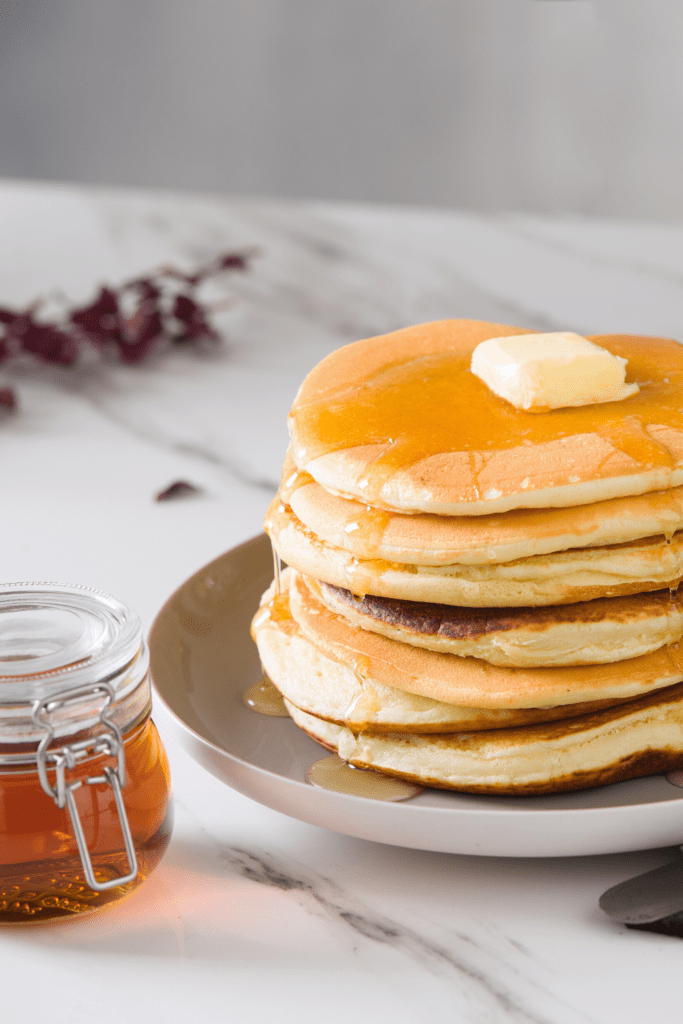 Stacks of Pancakes with Butter and Maple Syrup