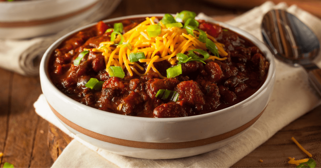 Chili Con Carne with Cheese and Chopped Onions