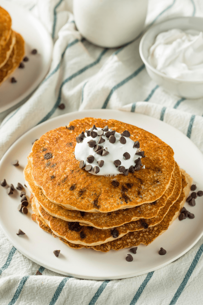 Stacks of Pancakes with Chocolate Chips and Whipped Cream