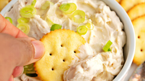 Dipping Biscuit into a Bowl of Clam Dip