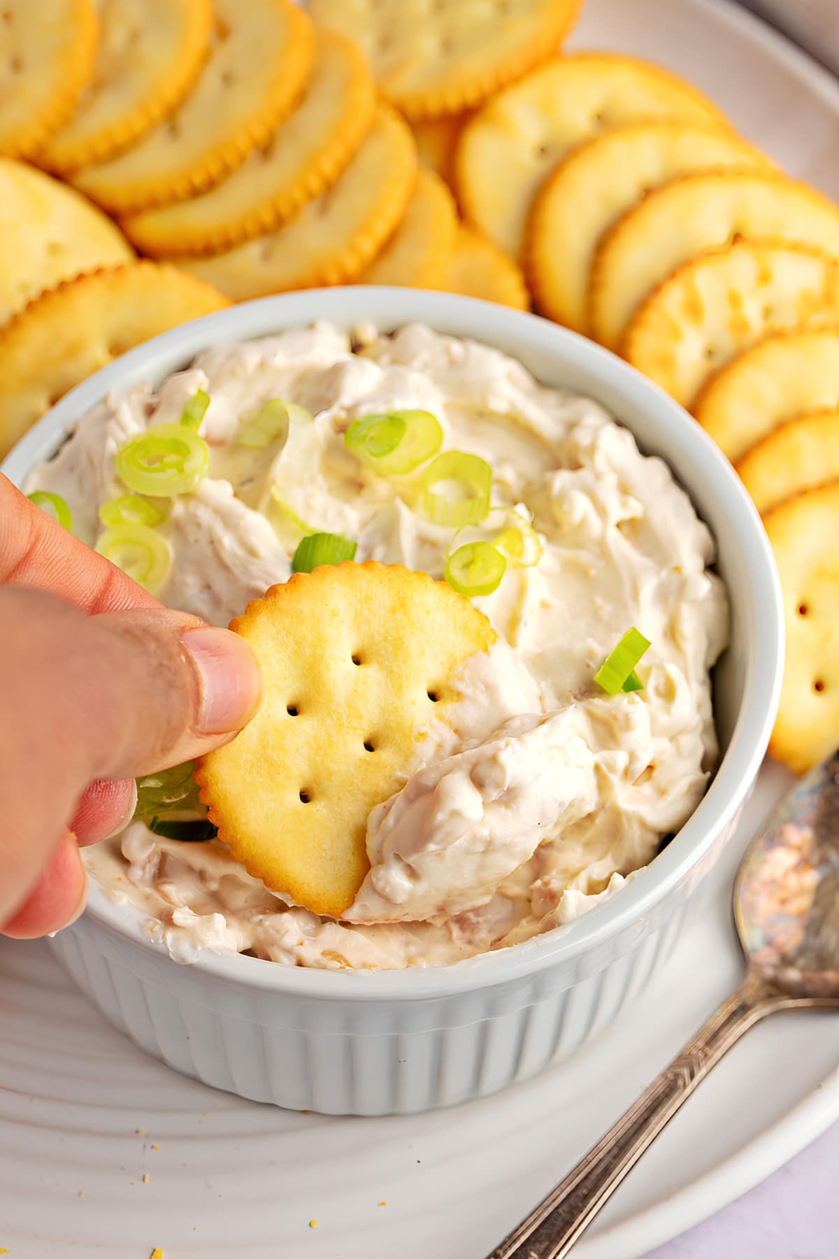Dipping Biscuit into a Bowl of Clam Dip