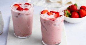Cold Strawberry Pink Drink with Strawberries in a Glass