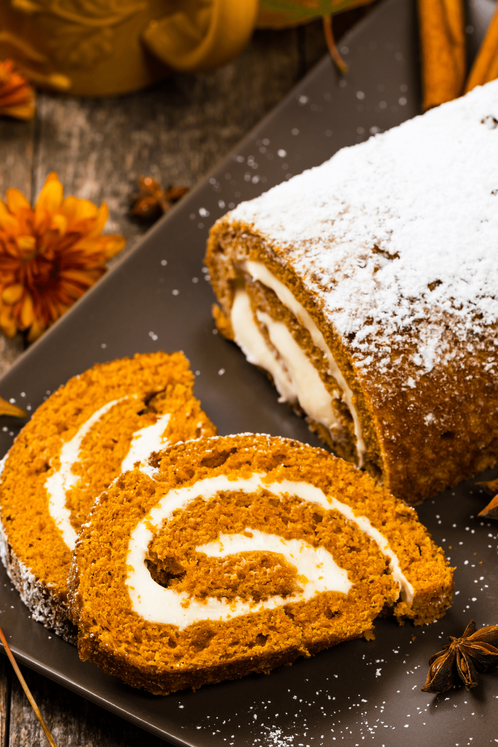 Pumpkin roll with cream filling sprinkled with powdered sugar.