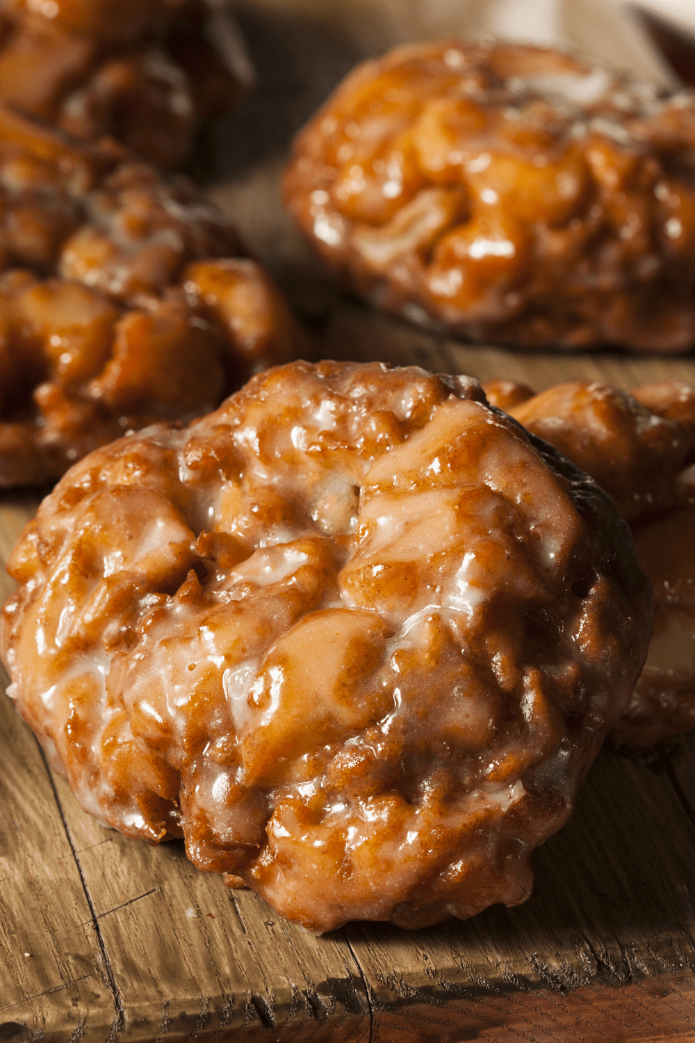 Apple fritters covered with sugar glaze. 