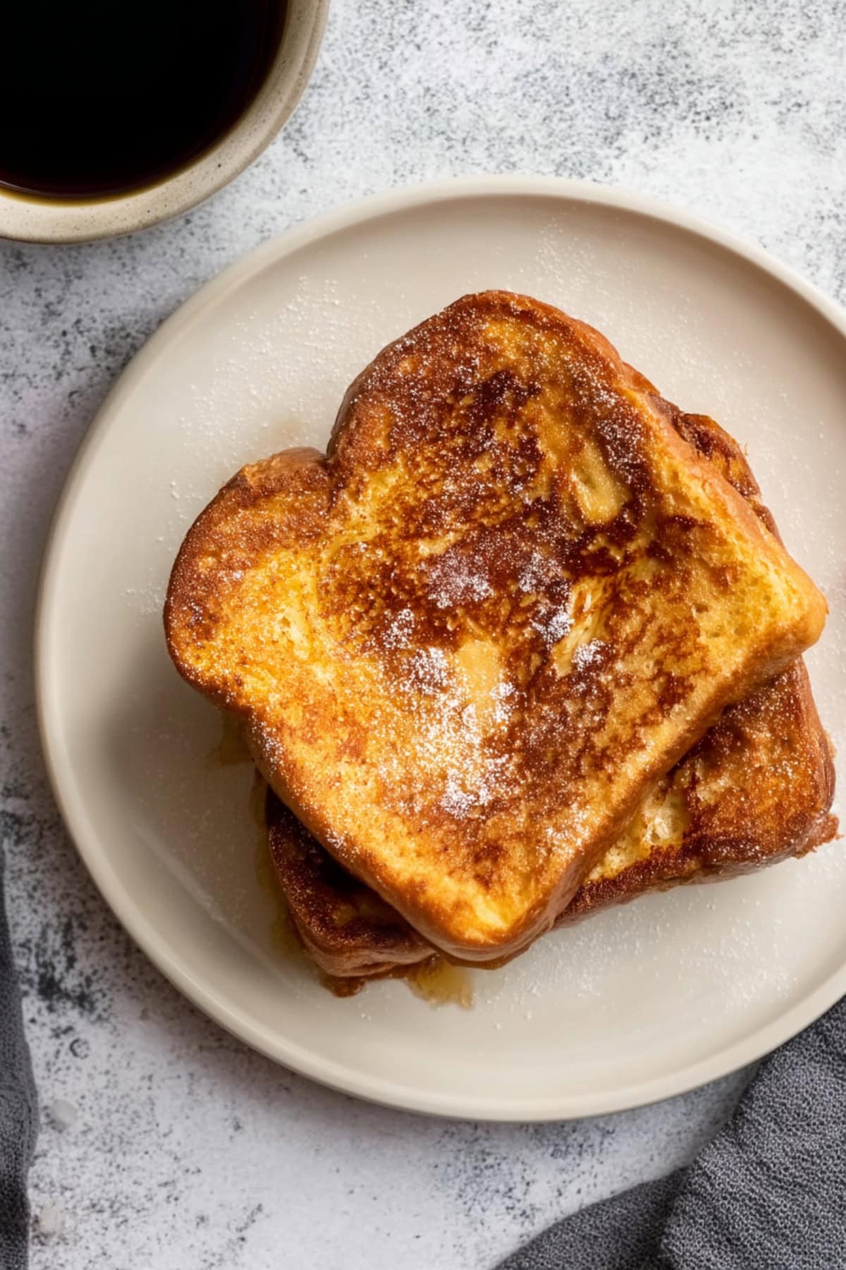 Overhead view of two sliced Baileys french toast in a plate.