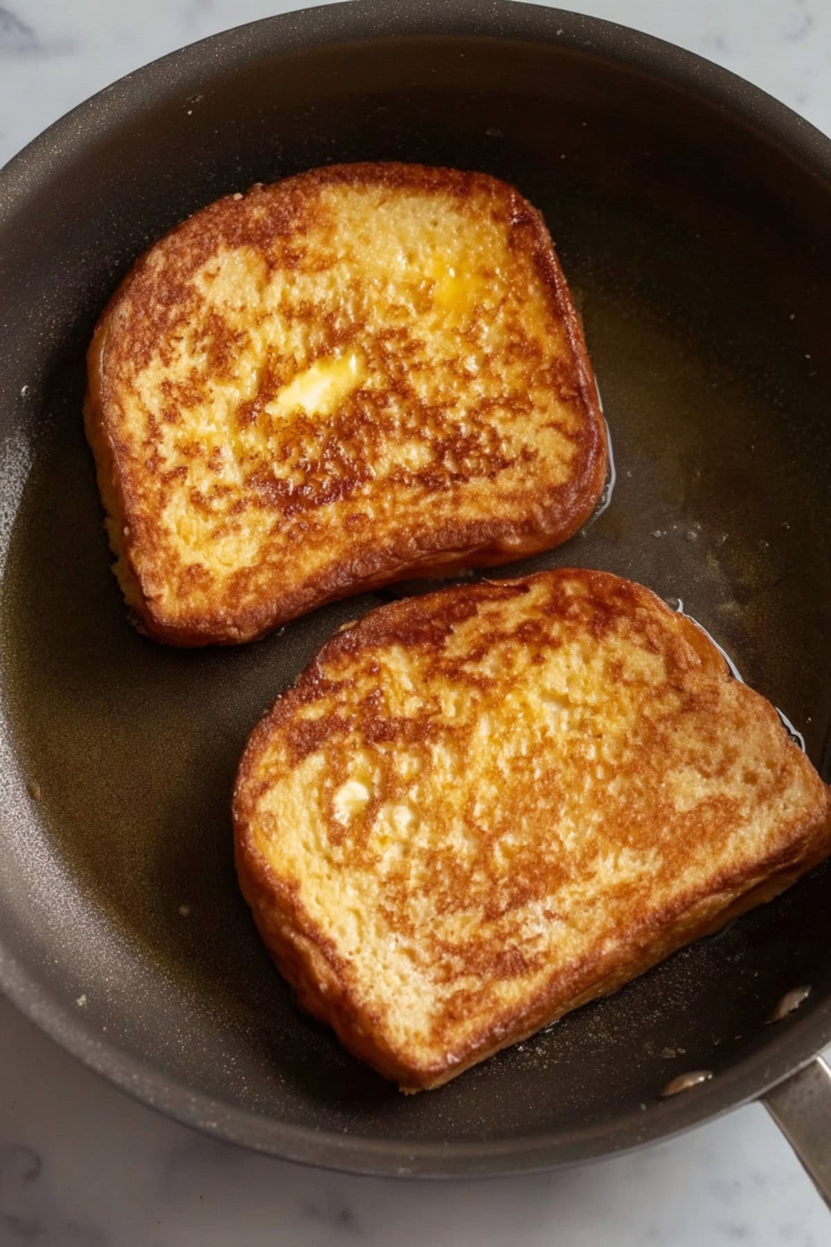 Two cooked sourdough in a pan.