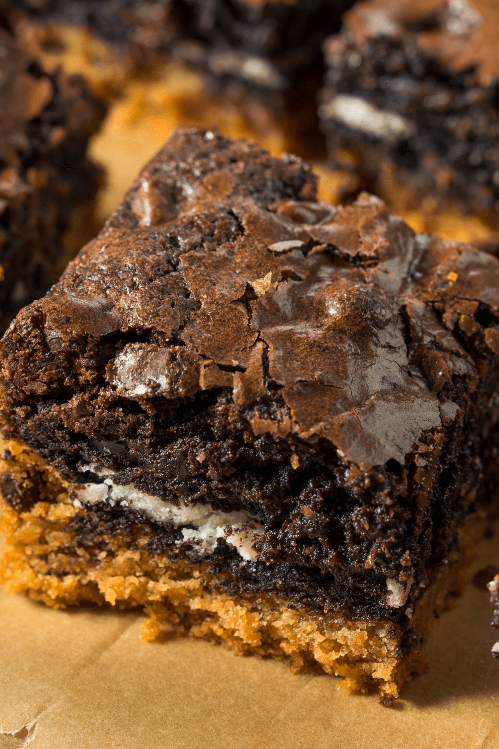 Closeup of slices of chocolate brownies with cookie dough bottom. 