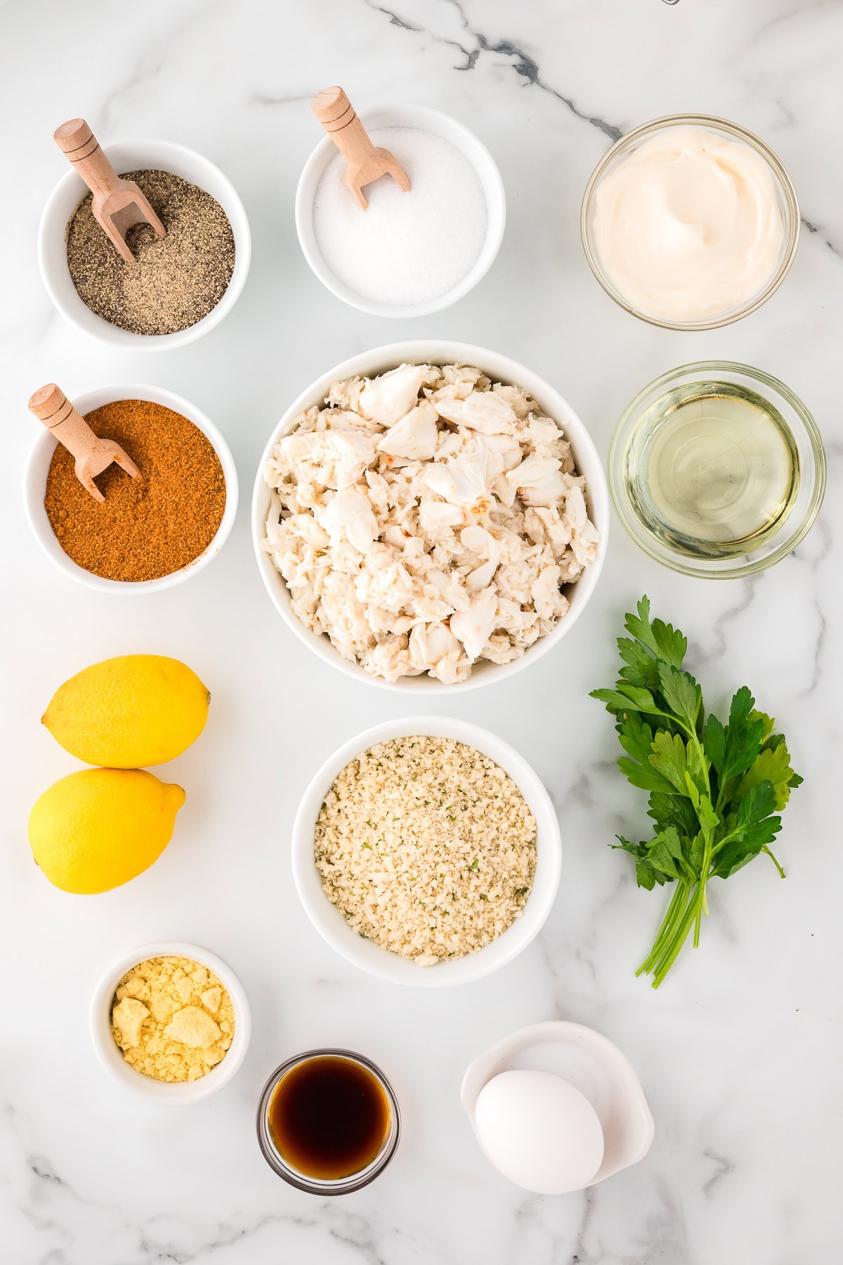 Crab cake ingredients: crab meat, parsley, mayonnaise and lemon zest