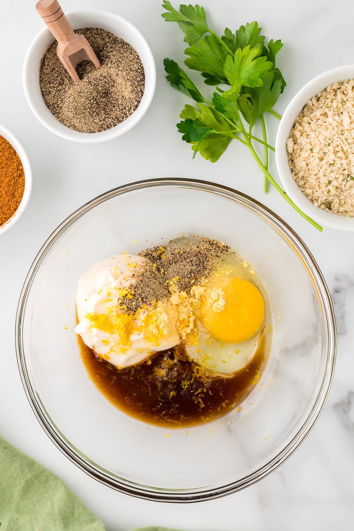 Mayonnaise, Worchestershire sauce, lemon zest and eggs in a mixing bowl