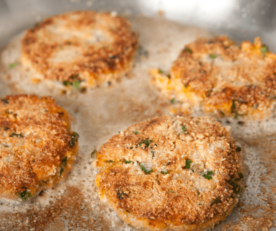Crab Cakes Cooking In Pan