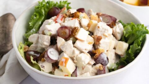 Homemade Chicken Waldorf Salad with Fruits, Walnuts and Lettuce in a Bowl
