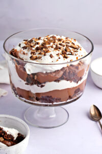 Homemade Death By Chocolate Trifle Filled with Whipped Cream and Brownies Topped with Crushed Chocolate Bars