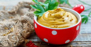 Homemade Hot Mustard Sauce with Seeds in a Red Bowl