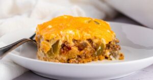 A Slice of John Wayne Casserole with Cheese and Spices in a Plate