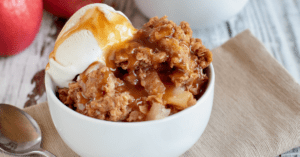 Apple Crisp with Ice Cream in a White Bowl