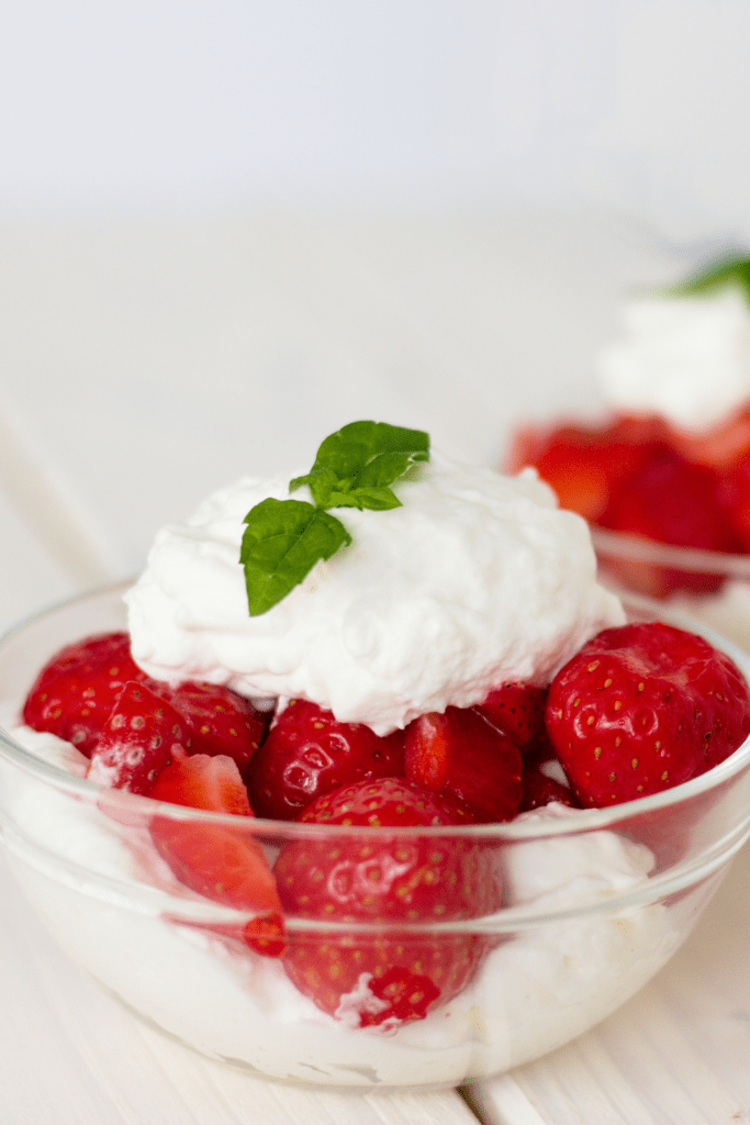 Strawberries with Whipped Cream in a Glass Bowl