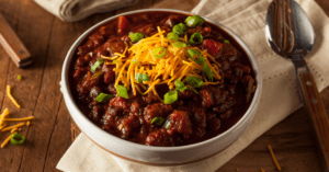 Homemade Bowl of Chili with Cheese and Chopped Onions