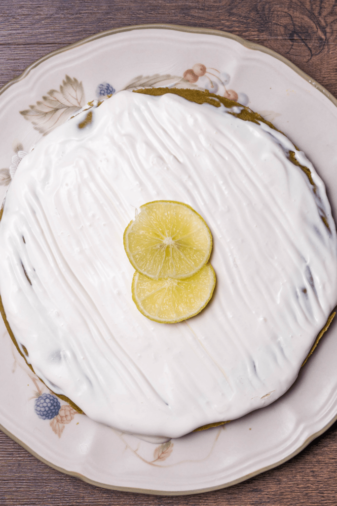 Homemade Key Lime Cake Topped with Sugar Icing and Limes