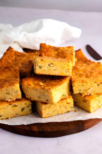 Mexican Cornbread Squares on a Cutting Board