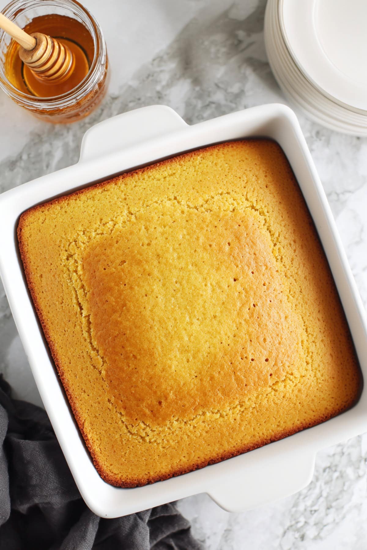A whole cornbread in an 8-inch pan, top view.