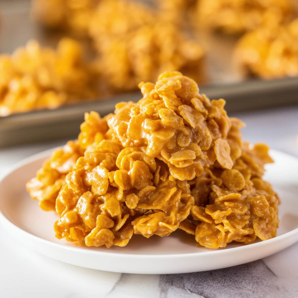 Peanut butter cornflake cookies in a white plate.
