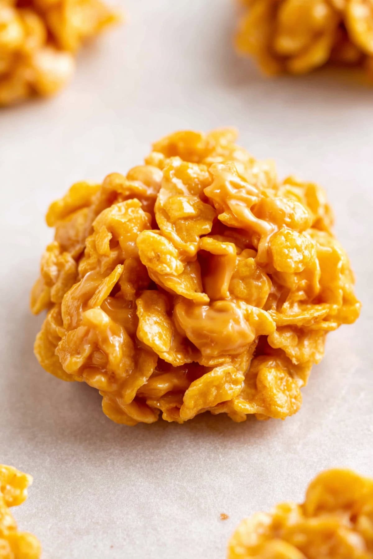 A piece of peanut butter cornflake cookies in a white parchment paper.