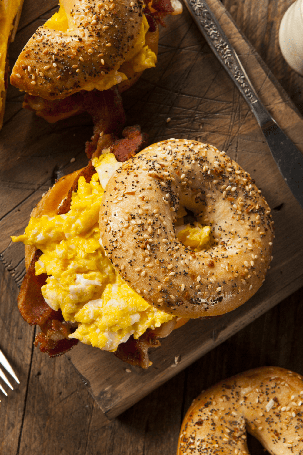 Homemade Breakfast Bagel Sandwich with Bacon, Egg and Sesame Seeds