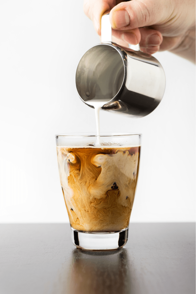 Pouring Milk into Iced Coffee Latte