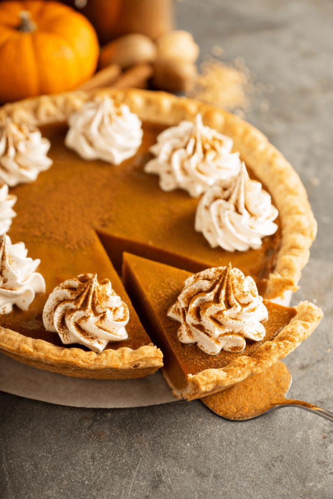 Pumpkin Pie with Whipped Cream and Cinnamon