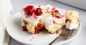 Slice of Sweet Homemade Heaven on Earth Cake with Cherry Pie Filling and Almonds