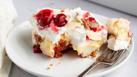 Slice of Sweet Homemade Heaven on Earth Cake with Cherry Pie Filling and Almonds