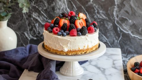 Whole New York Baked Cheesecake on a cake stand