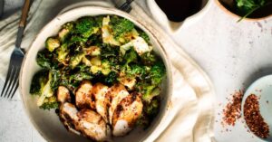 A Bowl of Stir-Fried Green Vegetables with Grilled Chicken and Garlic
