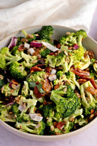 Creamy Broccoli Salad with Onions, Seeds and Bacon in a Bowl