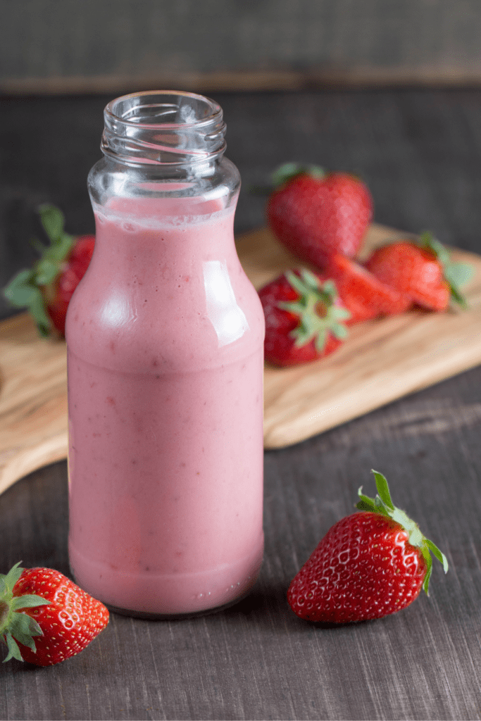Strawberry milkshake and fresh strawberries