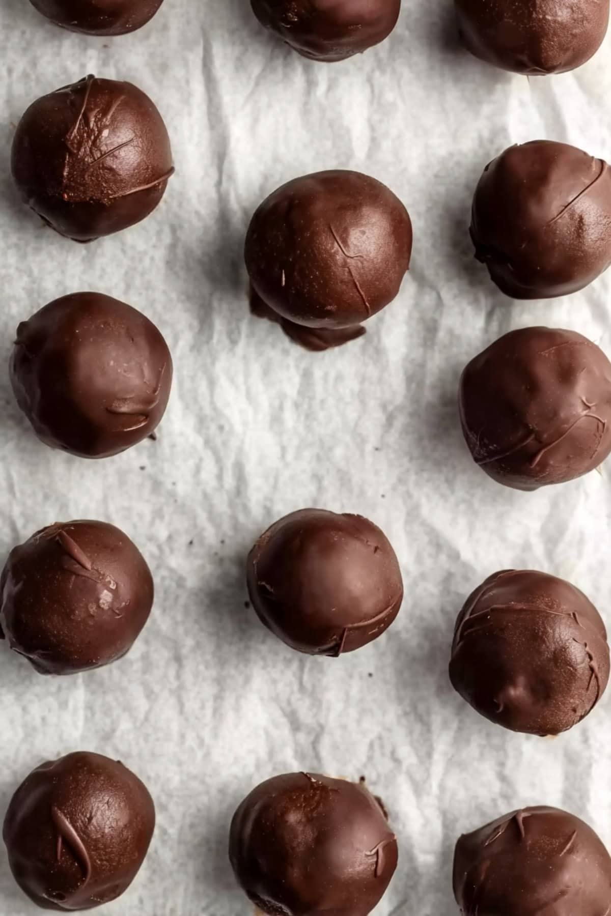 An overhead view of chocolate-covered peanut butter balls.