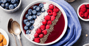 Smoothie Bowl with Raspberries, Blueberries and Coconut Flakes