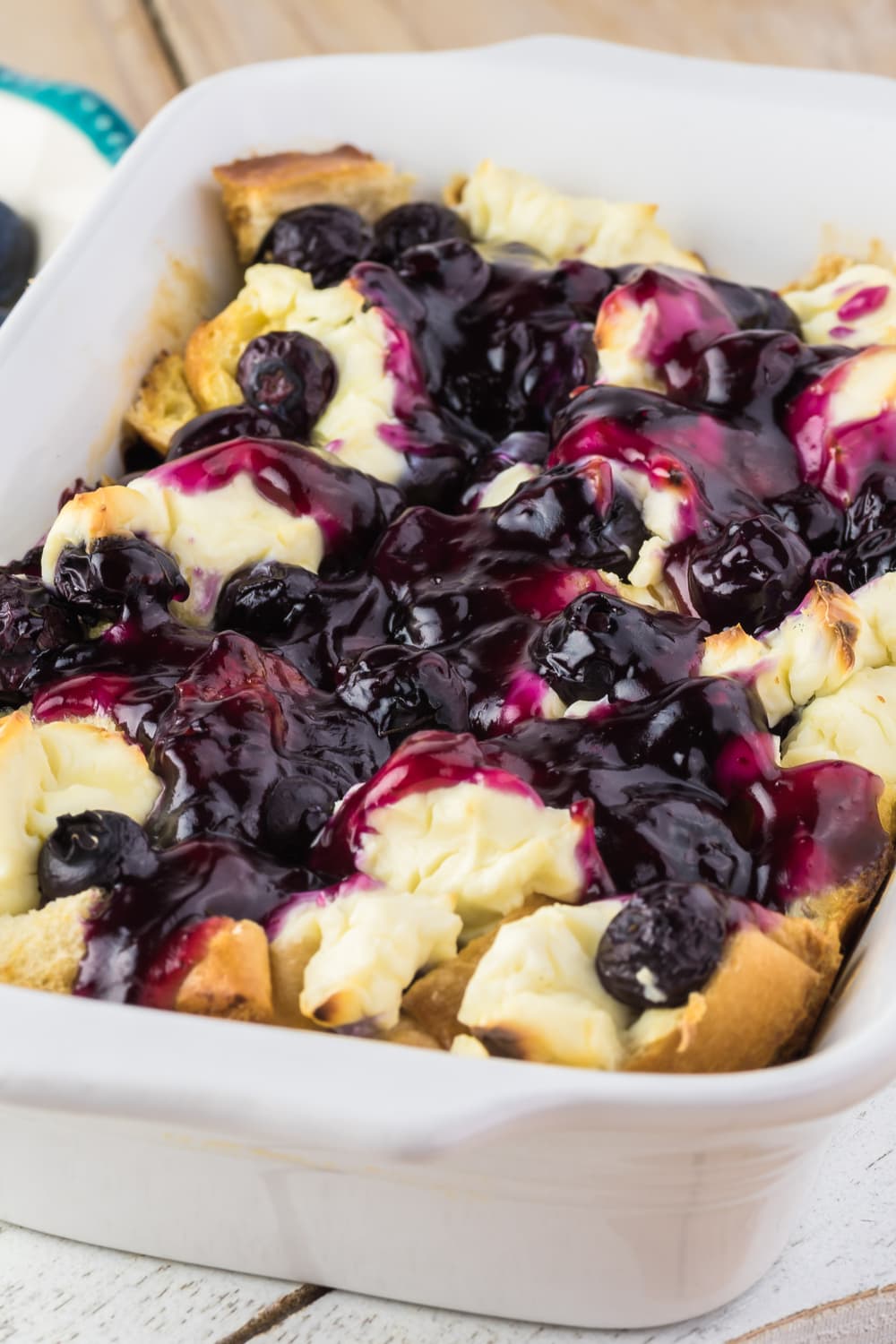 Breakfast Casserole full of blueberries, cream cheese, bread, and maple syrup.