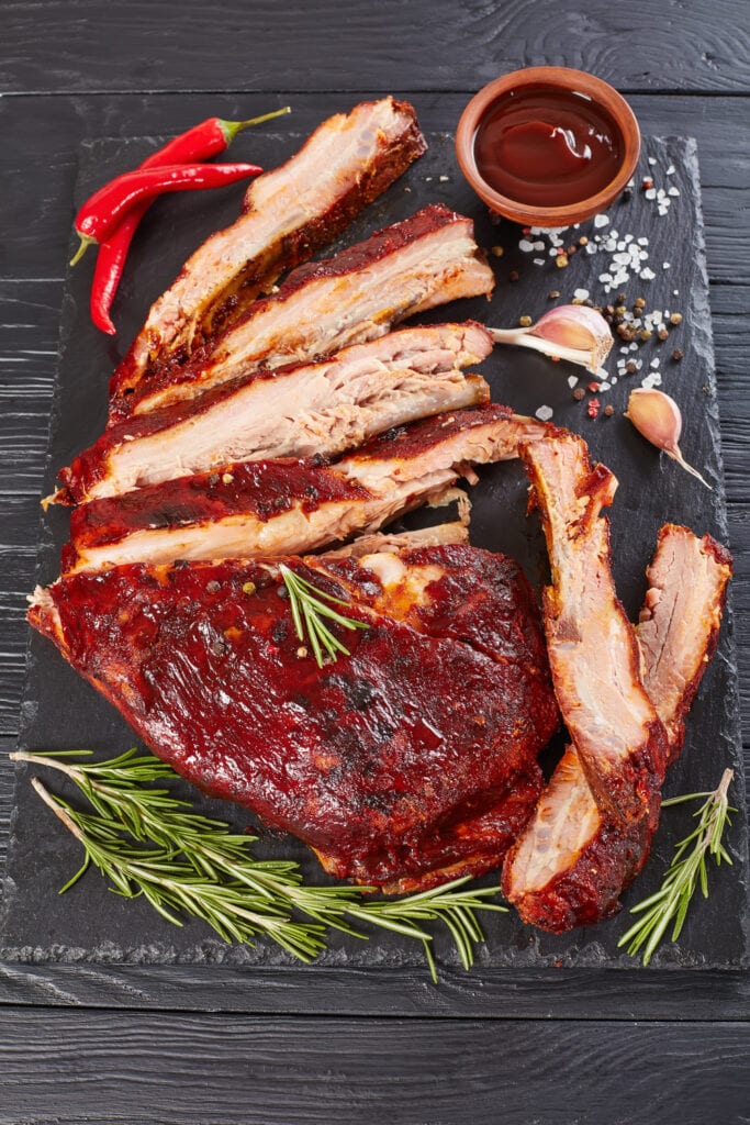 Fall Off The Bone Ribs served with a BBQ sauce that is smokey, sweet, and finger-licking good.